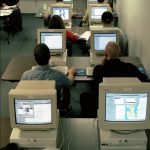 adults in a training classroom using computers