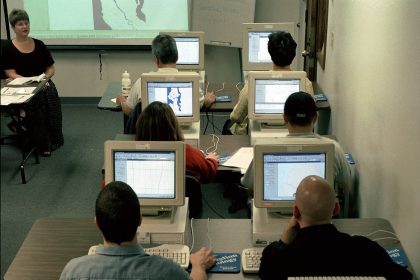 adults in a training classroom using computers