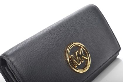 A smartphone in hand showing a wallet app