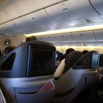 A business class airline seat in a modern aircraft cabin.