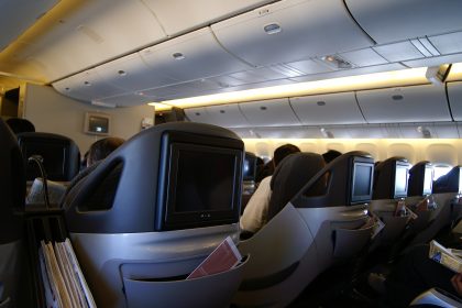 A business class airline seat in a modern aircraft cabin.