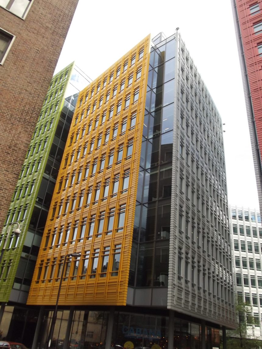 A modern glass office building in a city centre.