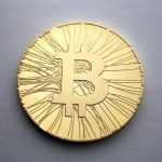 Physical commemorative bitcoin coins arranged on a desk