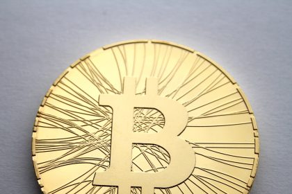 Physical commemorative bitcoin coins arranged on a desk