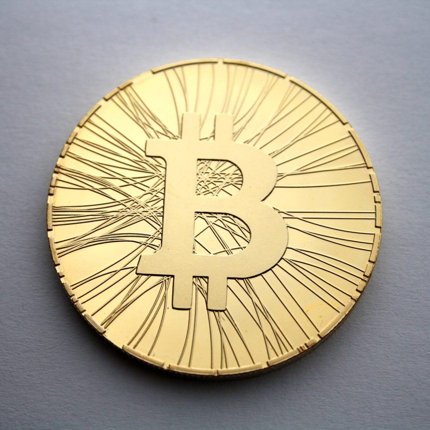 Physical commemorative bitcoin coins arranged on a desk
