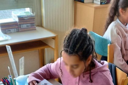 Students learning in a phone-free classroom, focused on their lesson